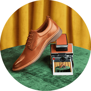 Comfortable Tan Amberjack shoes on top of a camera
