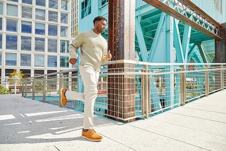 Man running down a balcony wearing Amberjack dress shoes