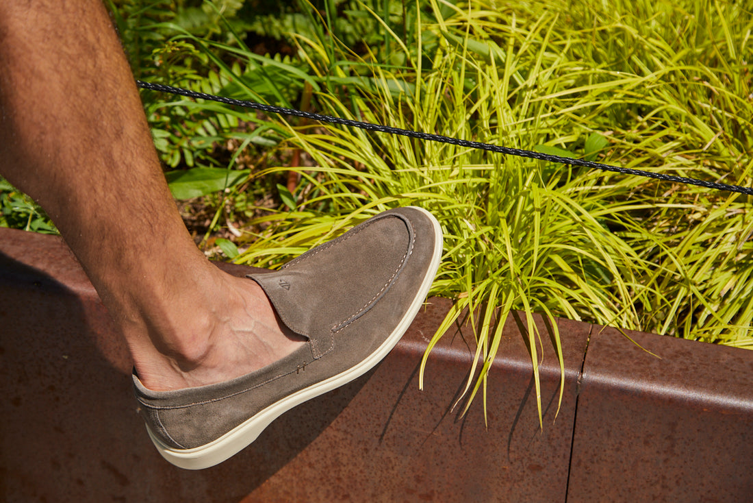 Man wearing a grey dress shoe